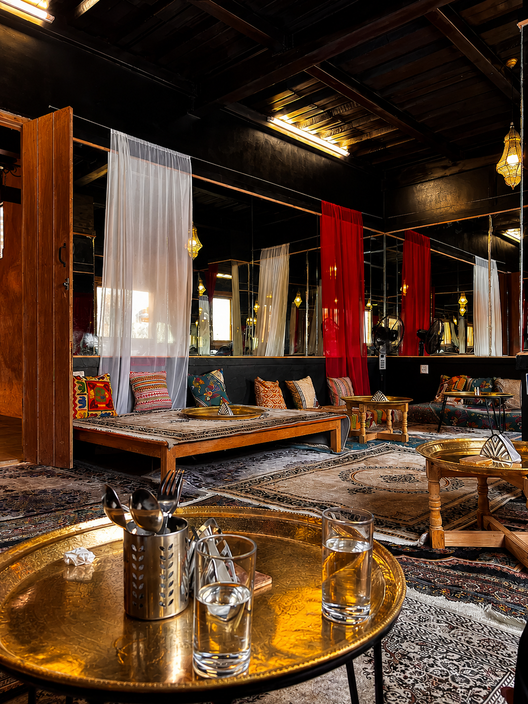 Dark wood, patterned rugs and low seating at The Chiya Spot Bhaktapur