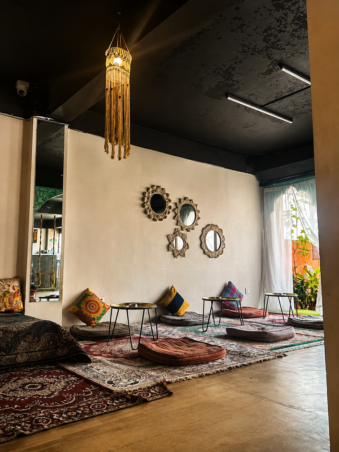 Floor seating and patterned rugs at The Chiya Spot Kumaripati in Lalitpur